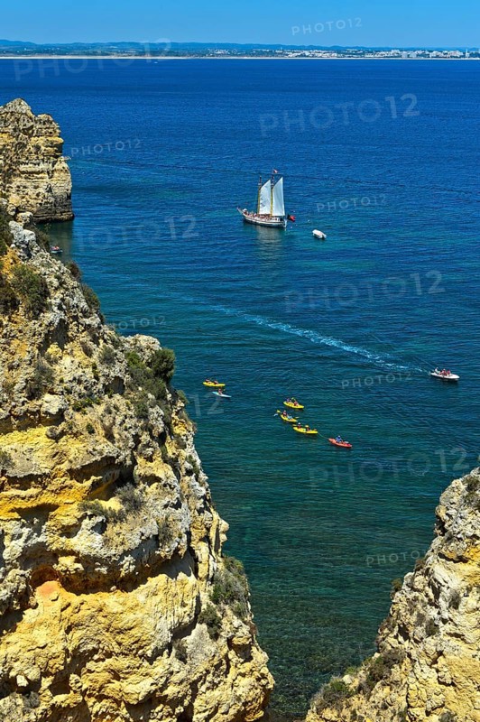 Sailing ship and sea kayaks off Camilo Beach