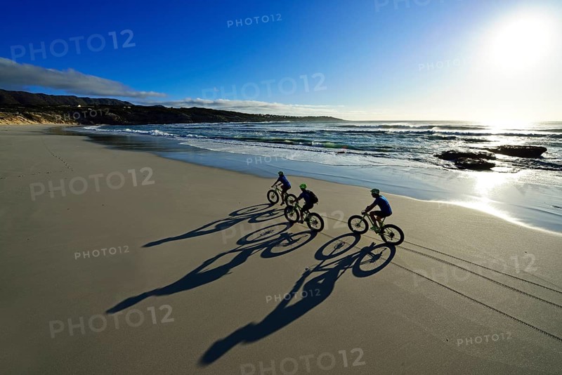 Mountain bikers with Fatbikes at the sandy beach