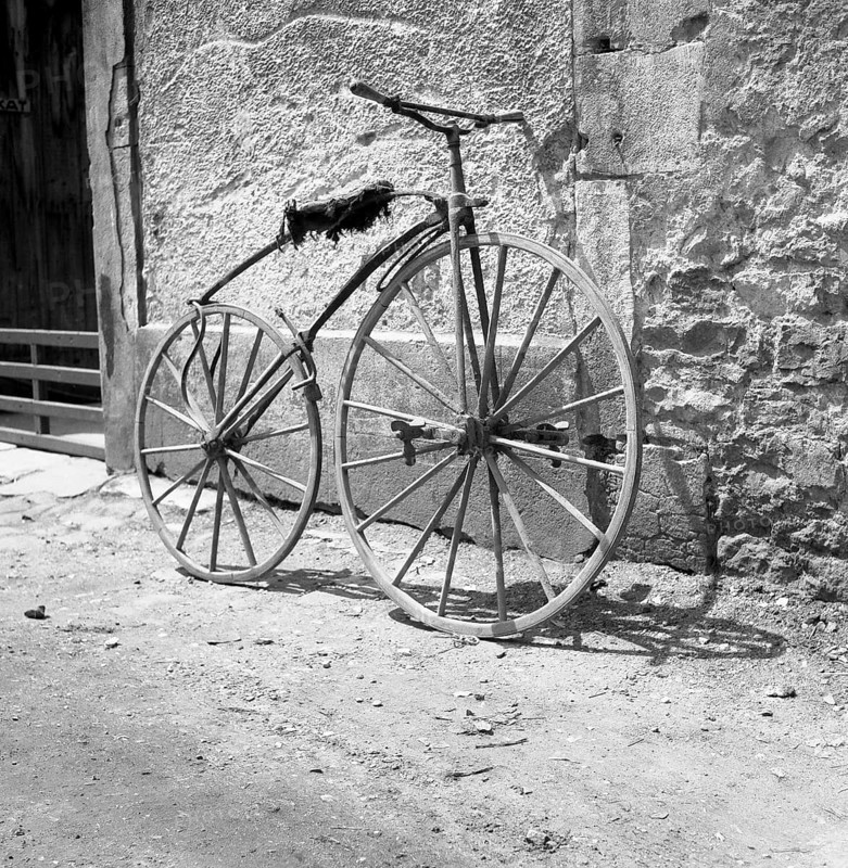 Pedal crank wheel leaning against a wall