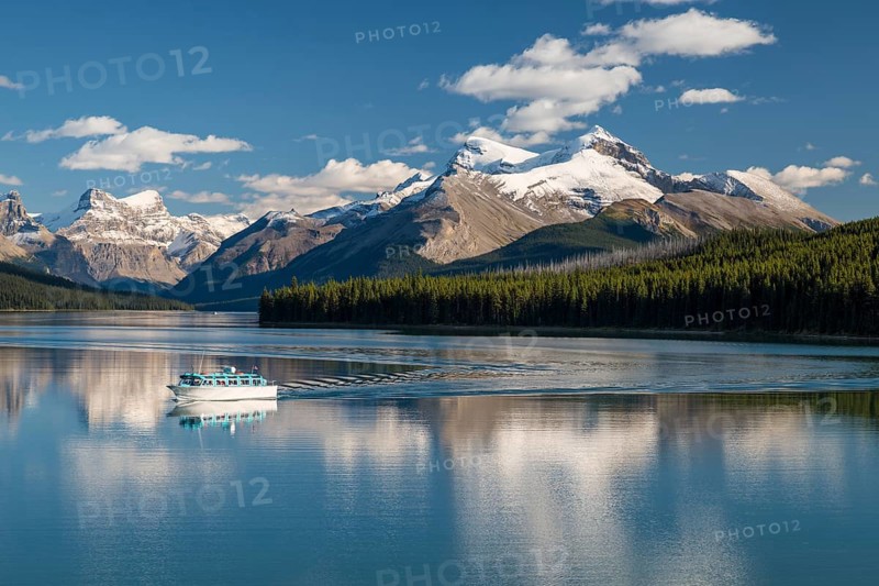 Excursion boat with tourists on Maligne Lake