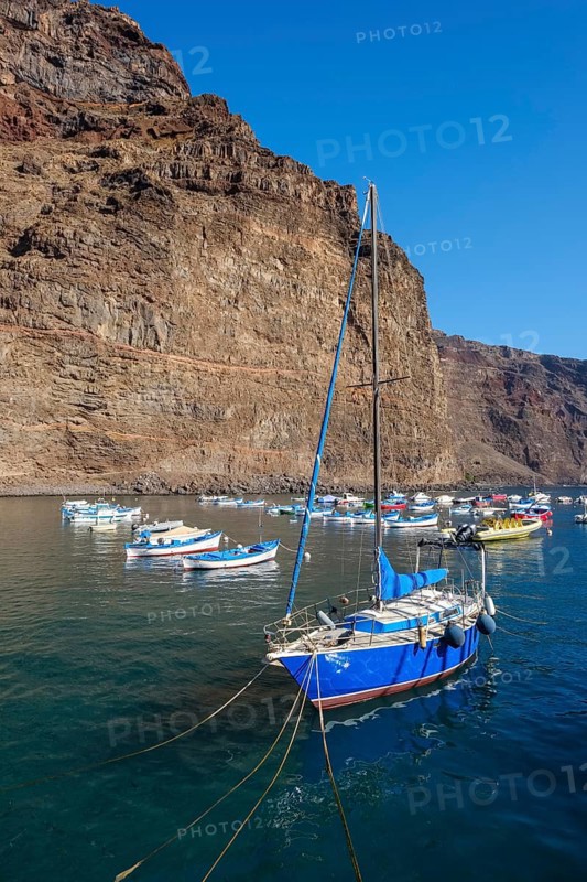 Fishing boats and sailing boat in the port