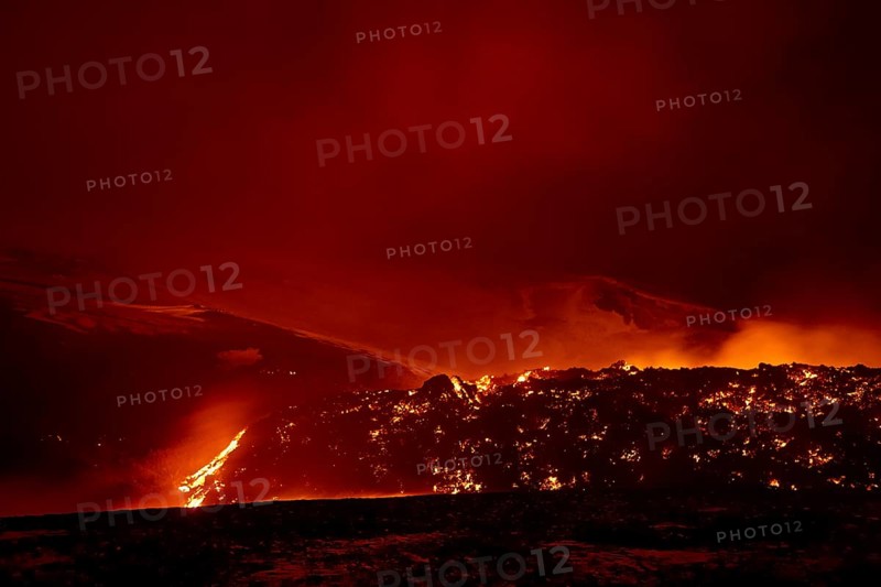 Glowing lava and lava flow at night at Fimmvorouhals volcano