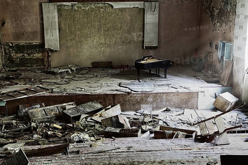 Stage with concert grand piano in destroyed building