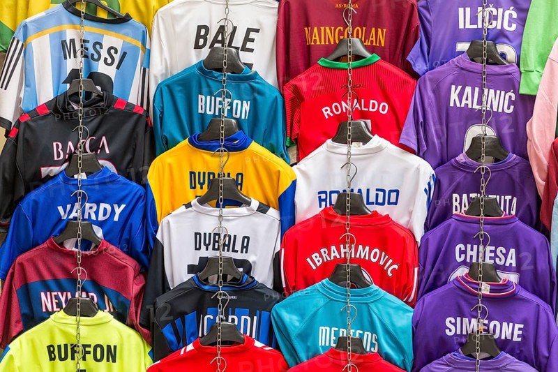 Football jerseys with names of football players for sale at sales stall