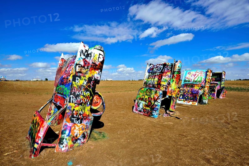 Painted Cadillacs rammed into the ground