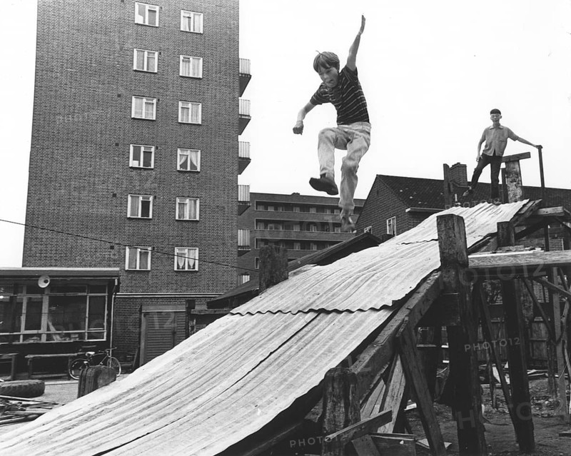 Boy plays on tin slide