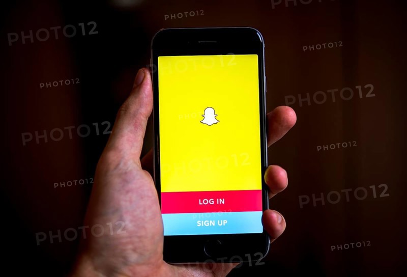 Hand holding iPhone with Snapchat App