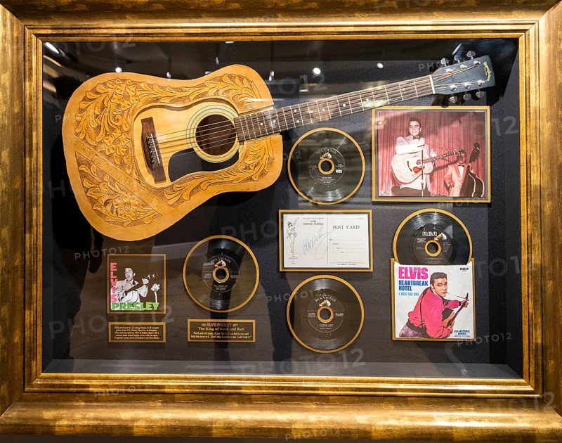 Guitar and records from Elvis Presley in a showcase