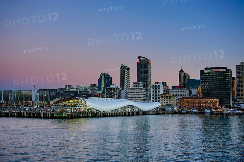 Illuminated waterfront with The Cloud during dusk