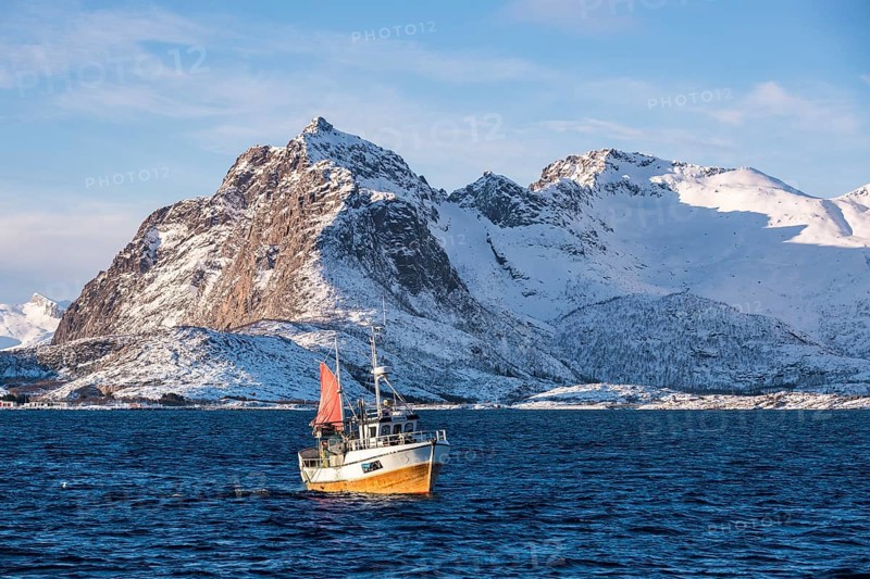 Traditional fishing boat catching the net