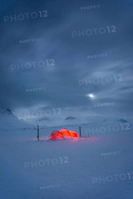 Tent by full moon in the snow
