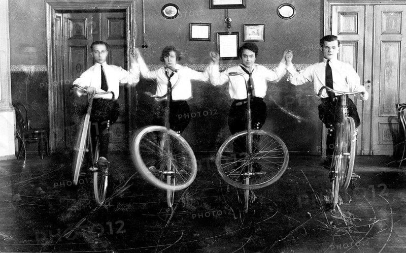 Four acrobats with bicycles