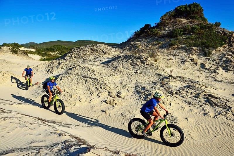 Mountain biking on fat bikes through dunes