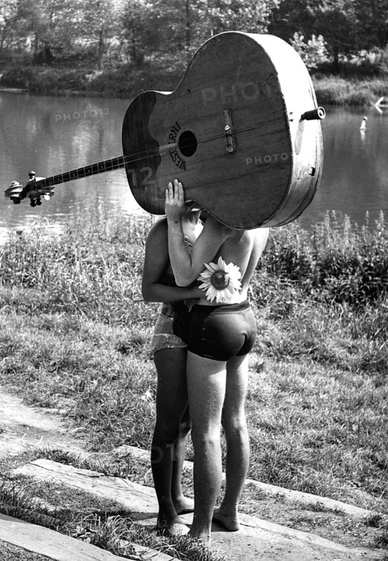 Pair behind big guitar ca. 1970s