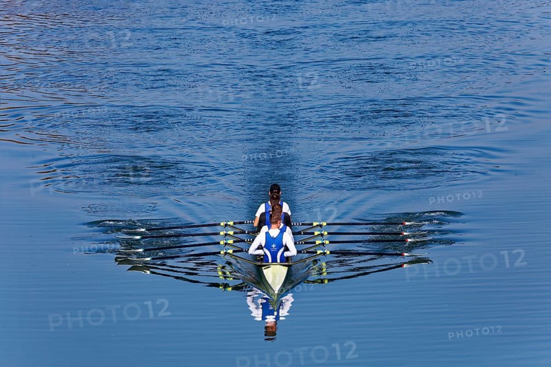 Rowers rowing in rowing boat