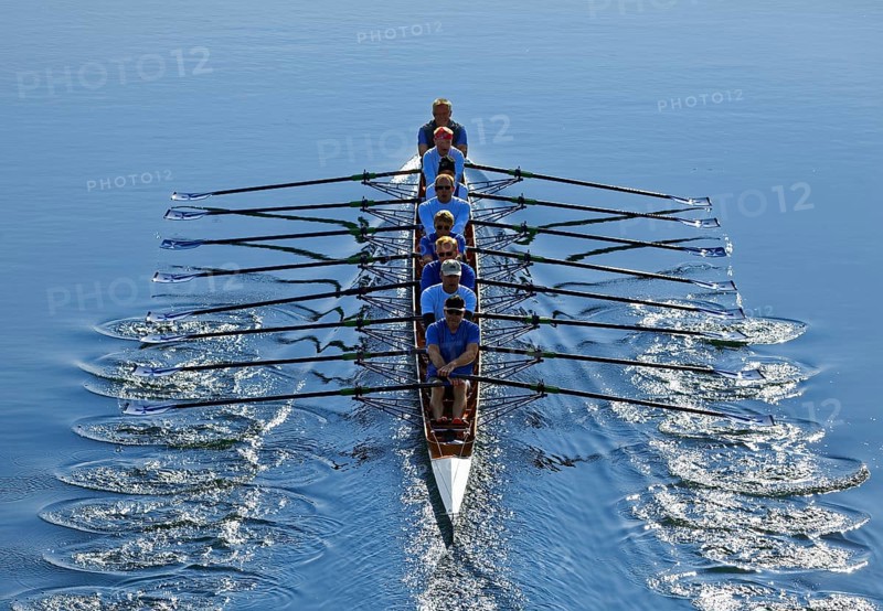 Rowers rowing in rowing boat