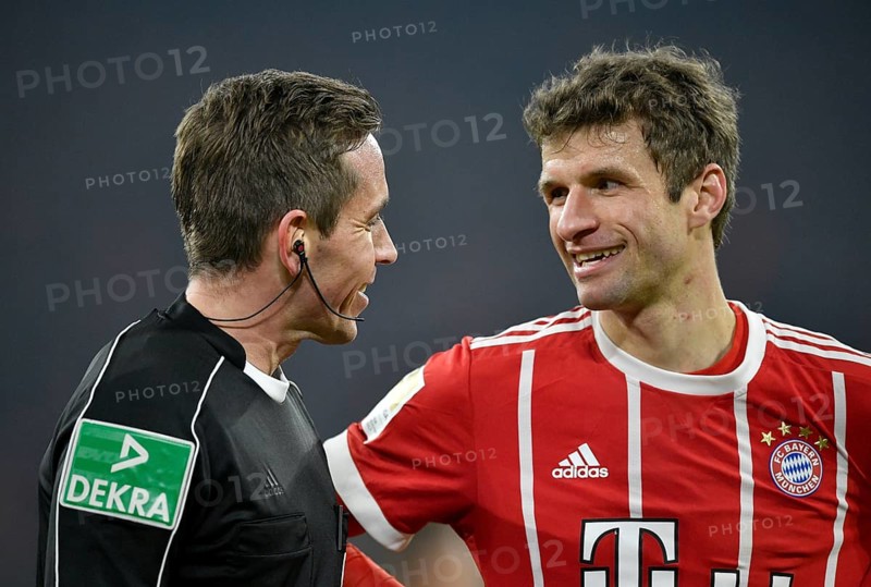 Referee Tobias Stieler in friendly dialogue with Thomas Muller of FC Bayern Munich