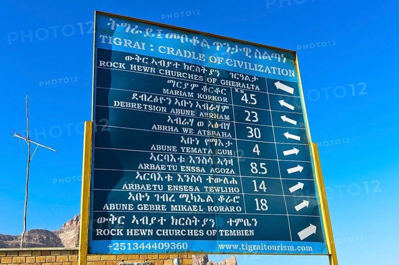 Bilingual signpost in English and Amharic showing rock churches in the Gheralta region