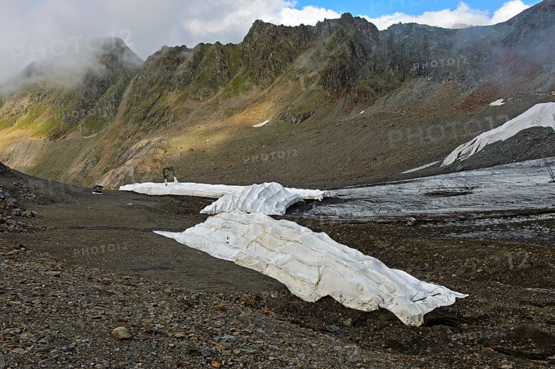 Covering of glacier ice with white plastic fleece to reduce glacier shrinkage in summer