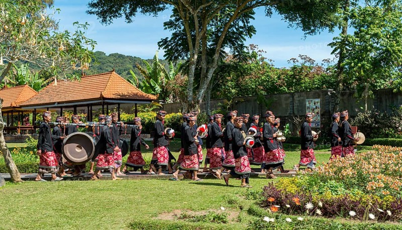 Procession of devout Buddhists with Gamealan musicians at the water temple Pura Ulun Danu Bratan