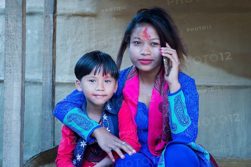 Nepalese woman with her son from the Tharu ethnic group