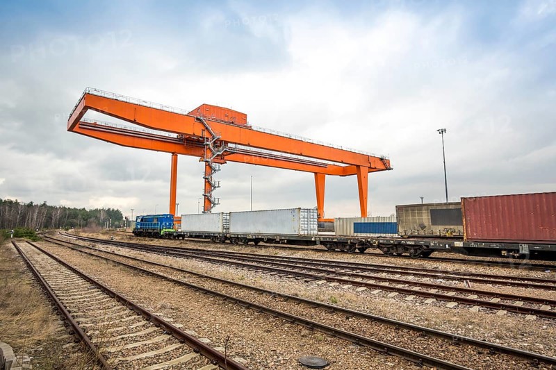 Cargo rail station with huge industrial overhead crane needed to railway transshipment