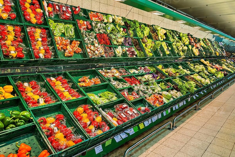 Shelf with packed vegetables in supermarket