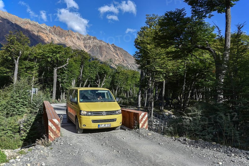 Yellow travel minibus on road to Lago del Desierto at Rio de las Vueltas