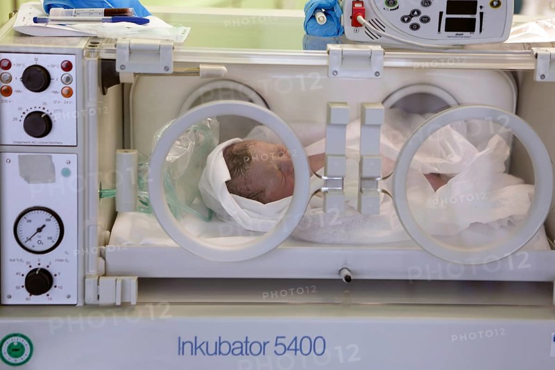 Newborn lying in incubator