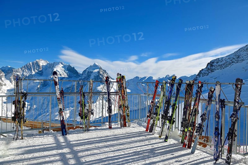 Ski parked in front of snowy mountain scenery