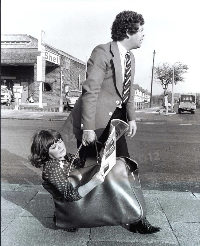 Man carries woman in bag