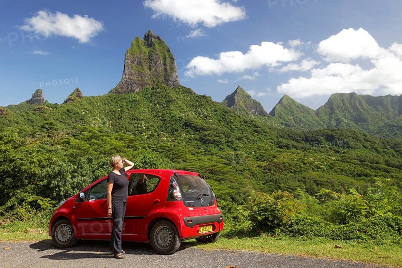 Woman with red car at Belvedere vantage point