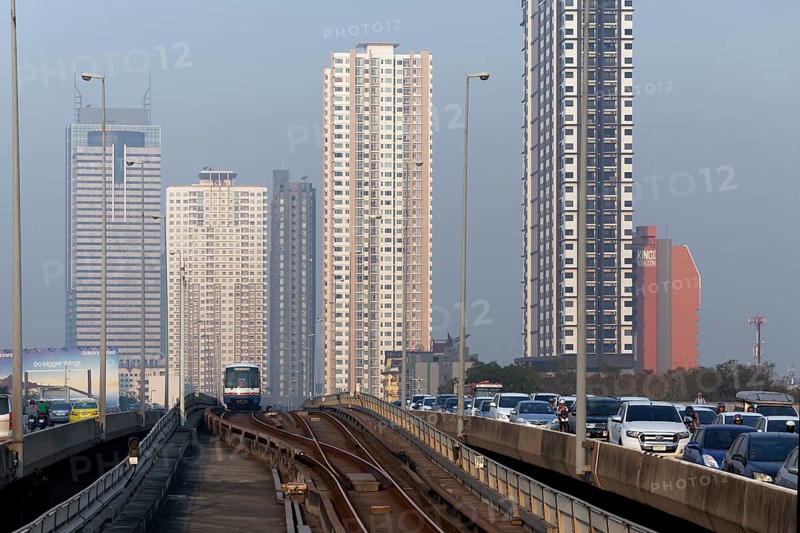 BTS Skytrain drives next to a motorcade