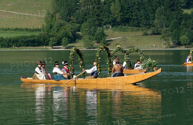 Men wearing traditional costumes in festively decorated squares
