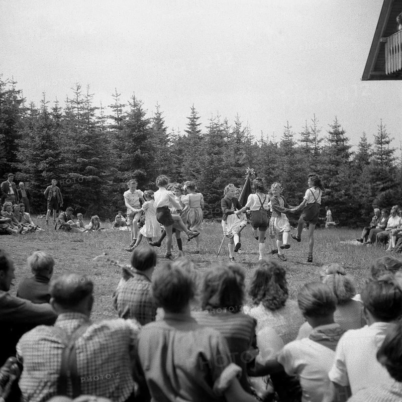 Children dance in a meadow