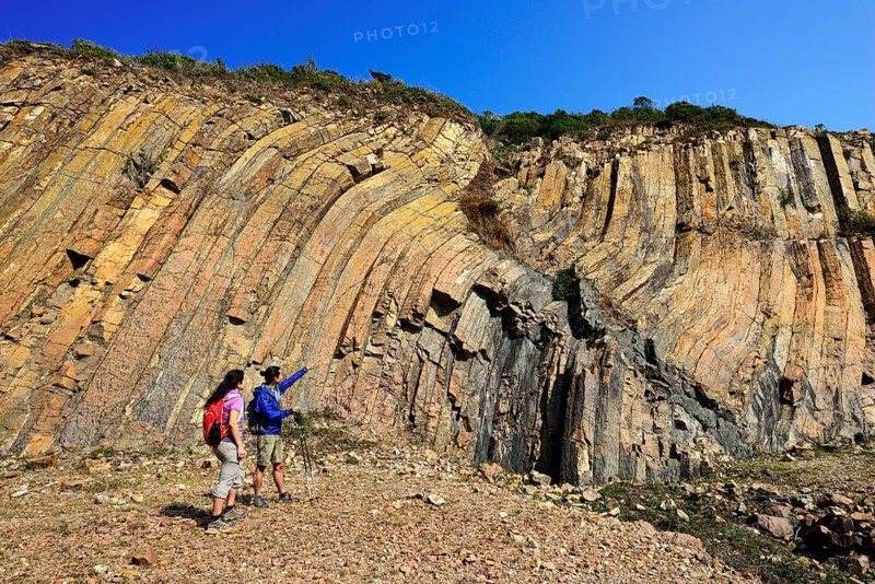 Hikers in front of Hexagonal Rock Columns in Geo Park