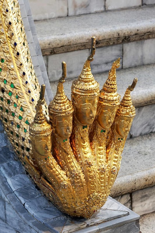 Golden foot with buddha heads as toes