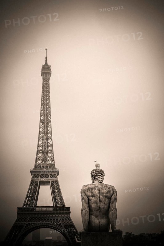 Eiffel tower and l'Homme (the Man) statue by artist Pierre Traverse