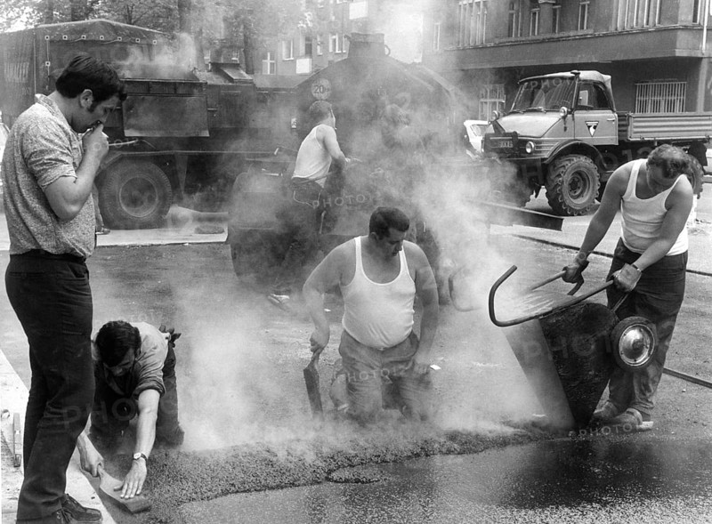 Road workers take tar to the streets