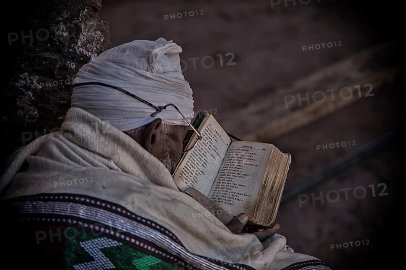 Coptic monk reads in book