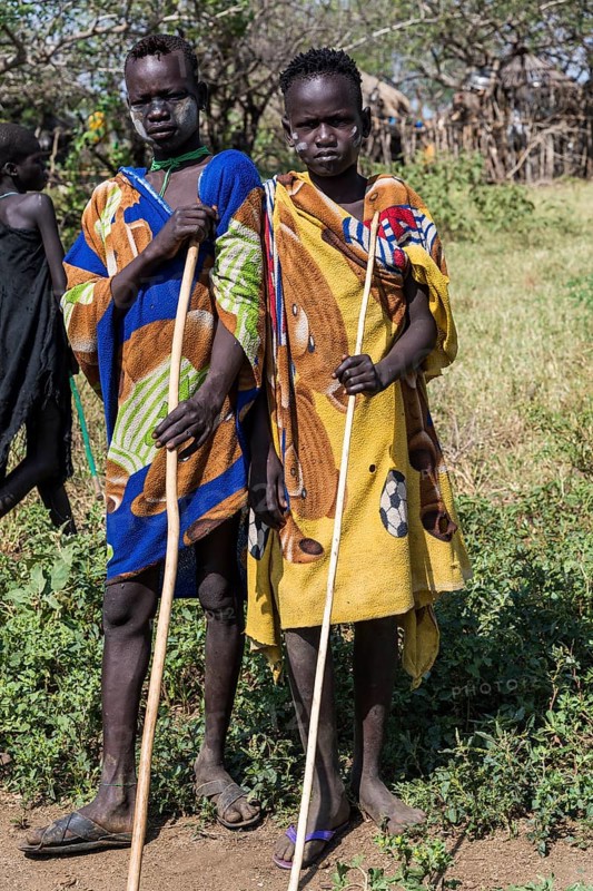 Two boys with sticks