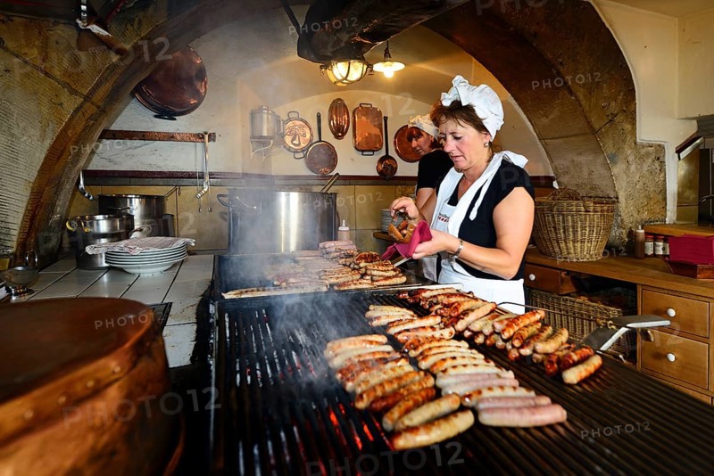Sausages sizzle on the grill