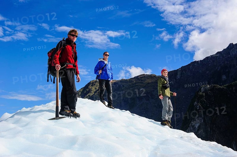 Tourists standing on the icefield of the Fox Glacier