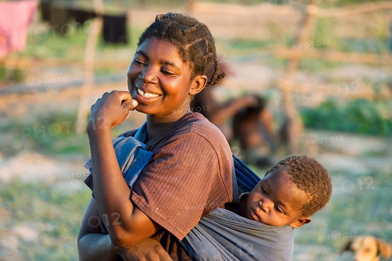 Tonga woman with child on her back