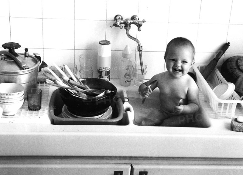 Baby plays in the sink