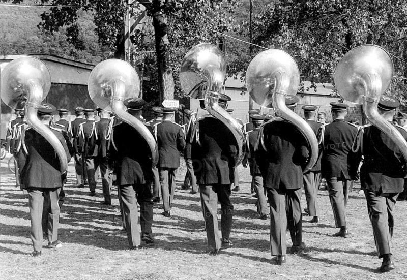 Five large wind instruments during a parade ca. 1955