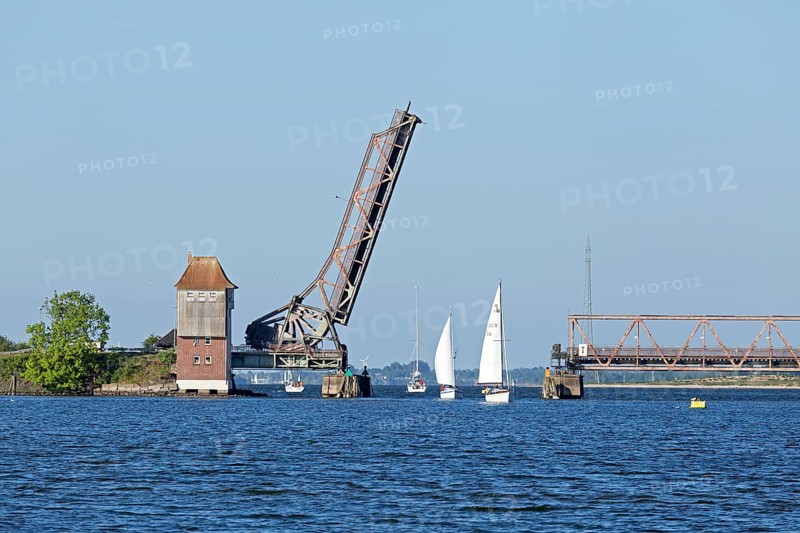 Sailboats sailing through open Schlei bridge