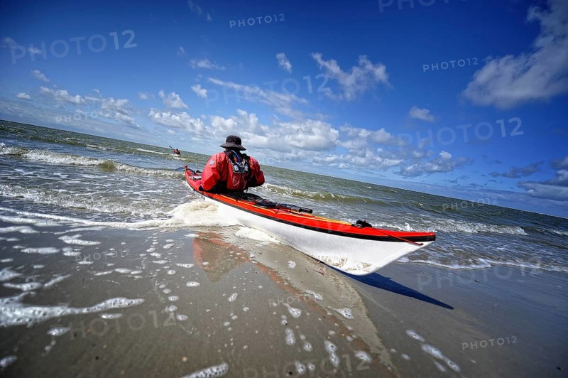 Canoeist in the surf on the beach of Langeoog