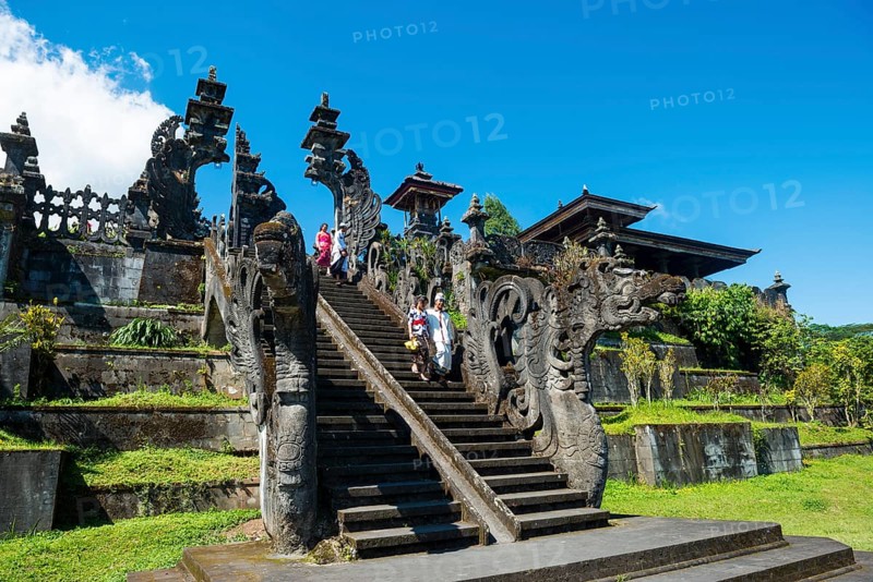 Balinese believers walk down stairs