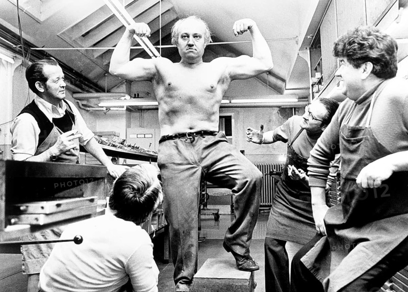 Strong man poses and shows his muscles
